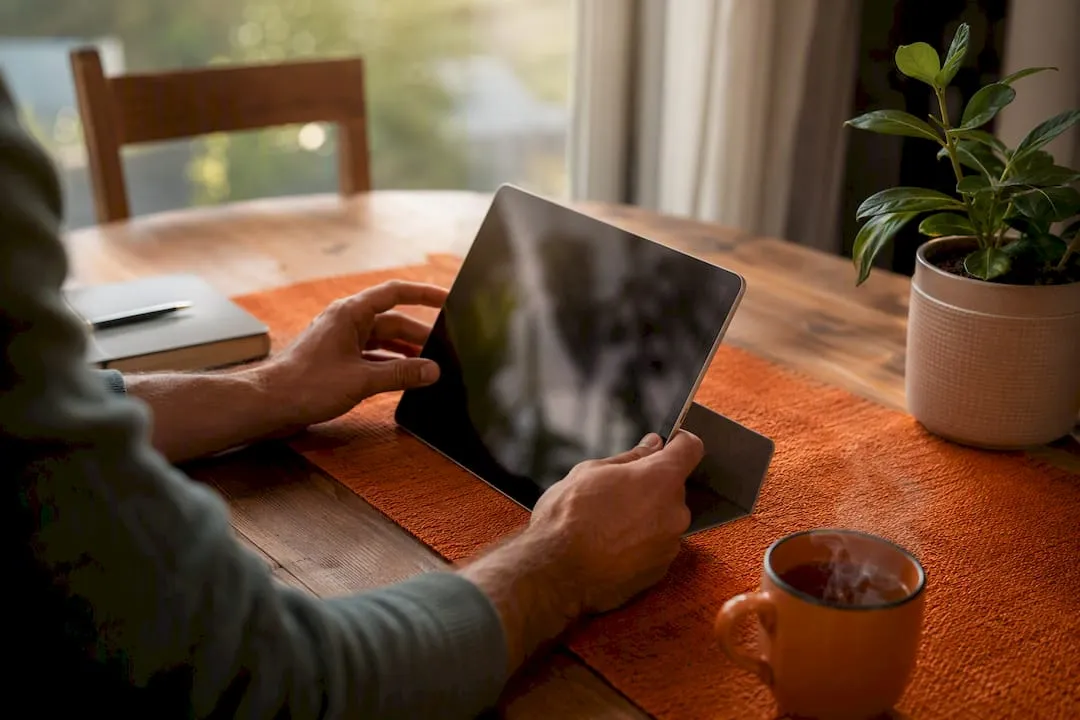 Hands adjusting digital calendar on tablet