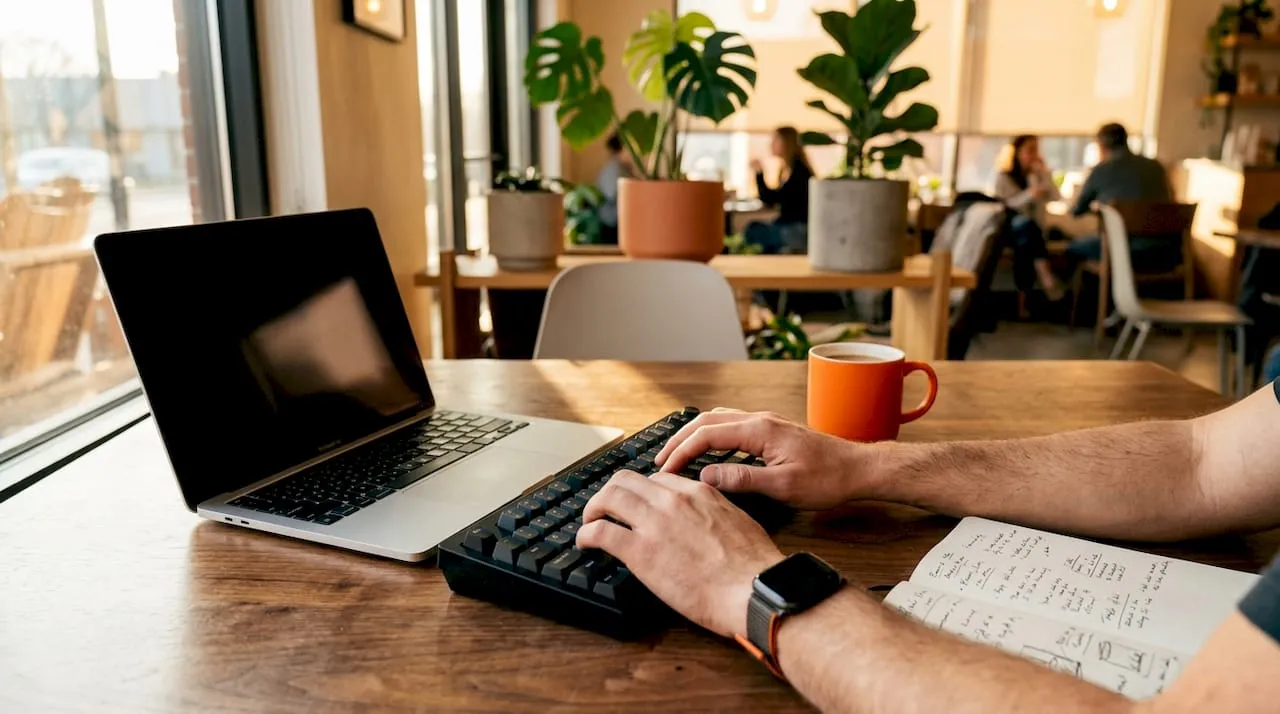 Hands typing on keyboard for data syncing
